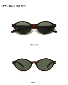 Detail of vintage oval tortoiseshell sunglasses with green lenses and silver hardware