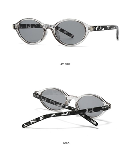 Detail view of oval sunglasses with transparent frames and marble patterned temples