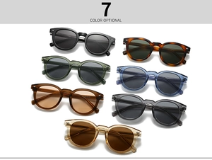 Flat lay of vintage round frame sunglasses in seven different colors on white background