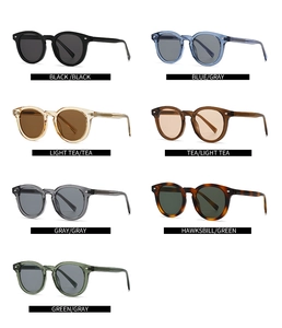 Flat lay of retro round sunglasses in seven colors with metal dots on transparent frames