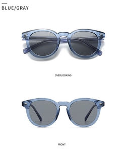 Detail view of vintage round blue sunglasses with gray lenses and metal diamond accents