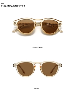 Detail view of champagne round sunglasses with diamond patterns and brown lenses