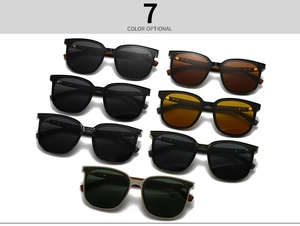 Flat lay of polarized sunglasses in 7 colors showing round frames and wood grain temples