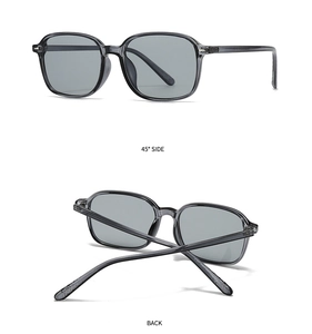 Detail view of modern square sunglasses with dark grey transparent frames at 45 degree angle
