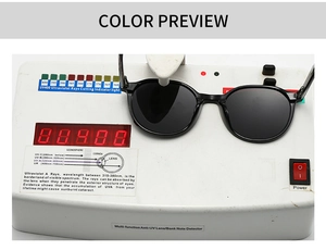 Detail showing round black sunglasses on a UV400 tester for anti-ultraviolet protection