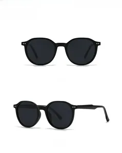 Front and 45-degree side views of classic round black sunglasses with metal stud details