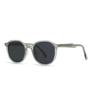 Modern round sunglasses with translucent gray frames and dark black lenses for unisex