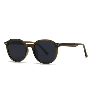 Retro round translucent olive green sunglasses with classic dark grey lenses and metal rivets