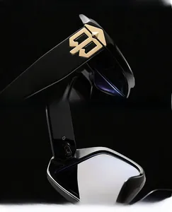Detail of square sunglasses featuring golden metal BB logo and smooth hinge structure