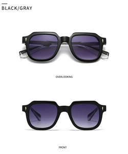 Detail of black polygon sunglasses with purple-gray gradient lenses and gold arrow accents