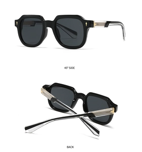 Detail view of black geometric sunglasses showing gold arrow accents and wire-core temples