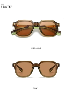 Detail view of tea-colored geometric sunglasses frames with decorative gold metal rivets