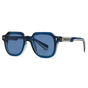 Stylish translucent blue polygon sunglasses with gold rivets on a white background