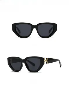 Detailed view of black square sunglasses with a signature golden H-shaped metal buckle
