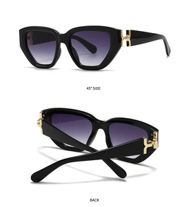 Detail of square cat-eye sunglasses with gold H-hinge and purple gradient lenses