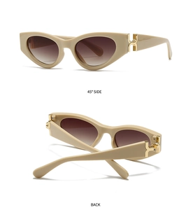 Détails des lunettes de soleil œil-de-chat avec charnière en métal doré et verres dégradés