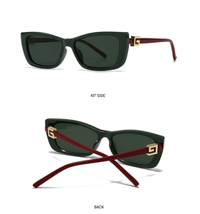 Detail of cat-eye sunglasses featuring dark green frames and burgundy temples with gold hinges