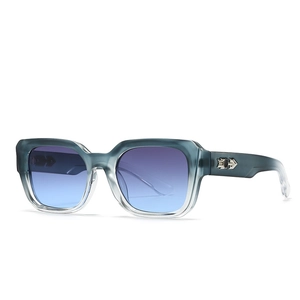 Detail of dark teal translucent sunglasses frame with silver arrow metal accent and gradient lens