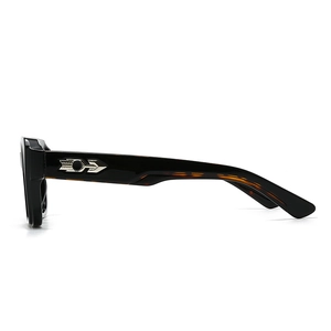 Detail of tortoiseshell acetate sunglasses temple with silver metal arrow inlay