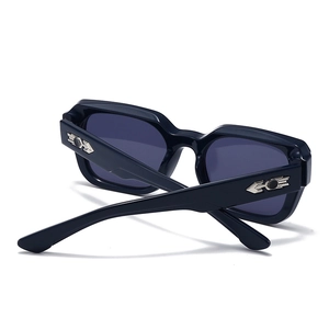 Detail of square black sunglasses with silver metallic arrow-shaped temple decoration