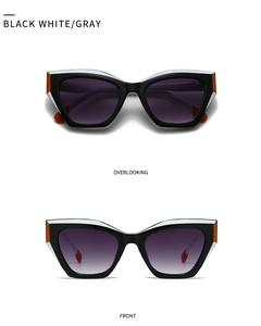 Detailed top and front view of cat-eye sunglasses with black, white, and orange frames
