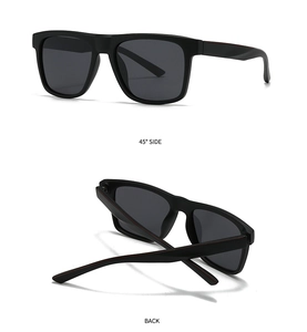 Detail of square polarized sunglasses with matte black frames and red temple accents