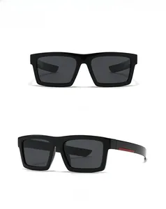 Detail view of square polarized sunglasses with sleek black frames and red temple accents