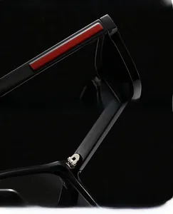 Close-up of polarized sunglasses featuring red stripe temple design and quality metal hinges