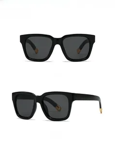 Front and side view of oversized square black sunglasses with gold metal temple tips