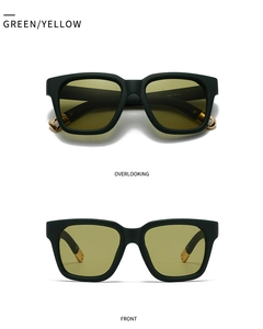Detail of dark green matte frames with yellow lenses and gold metal ball tips on sunglasses