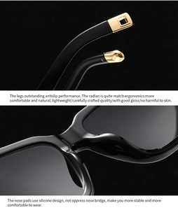 Detail of glossy black sunglasses frame featuring gold temple tips and silicone nose pads