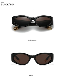 Detail view of black cat-eye sunglasses with tea lenses and gold temple accents