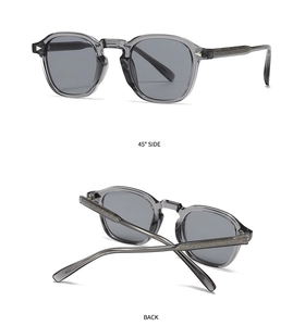 Detail view of translucent gray eyewear with metal core and silver triangular studs