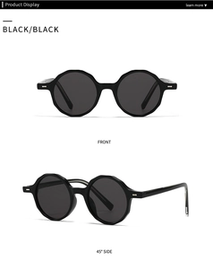 Gros plan sur des lunettes de soleil rétro noires avec bords polygonaux et détails argentés