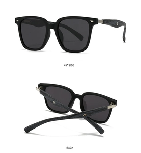 Detail view of polarised sunglasses with matte black frame and grey wood-grain temples