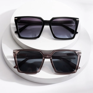 Square oversized sunglasses in black and translucent grey on white display stands