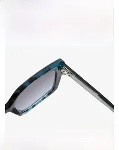 Detailed macro view of durable metal hinges and tortoise texture on square sunglasses