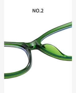 Macro shot of green transparent acetate frame showing integrated nose pads and bridge detail