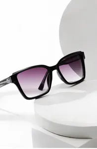 Detail of square black sunglasses with purple gradient lenses and marble patterned temples