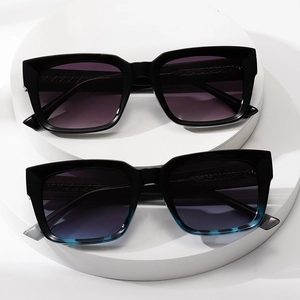Modern oversized square sunglasses with purple gradient lenses and blue patterned frames