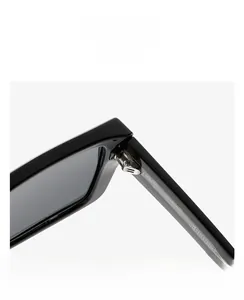 Macro view of a durable metal hinge on a square black acetate sunglasses frame