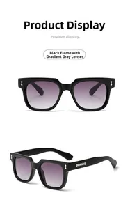 Detail einer eckigen schwarzen Sonnenbrille mit grauen Verlaufsgläsern und Silberdekor