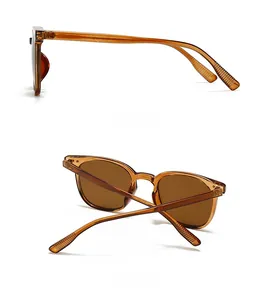 Detail view of classic amber square sunglasses with deep brown lenses and a lightweight frame