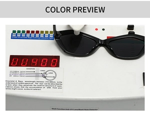 Detail view of black cat eye sunglasses showing UV400 protection on a testing device
