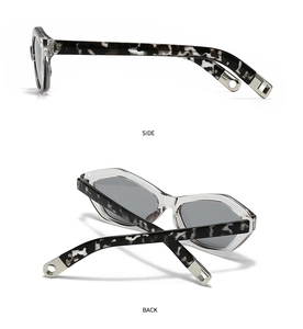 Detail view of angular cat-eye sunglasses with tortoiseshell temples and metal accents