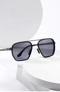 Detail view of square black sunglasses with double bridge and gunmetal metal temples
