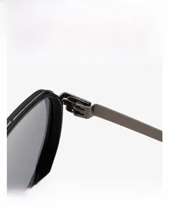 Detailed close-up of durable metal hinge and temple of narrow rectangular sunglasses