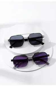 Detailed view of black and purple geometric sunglasses on minimalist podiums