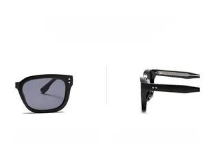 Detail view of black square oversized sunglasses with silver diamond rivets and dark lenses
