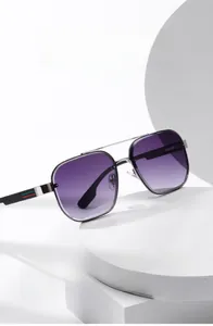 Detail of pilot sunglasses with purple gradient lenses and red-green striped metal temples